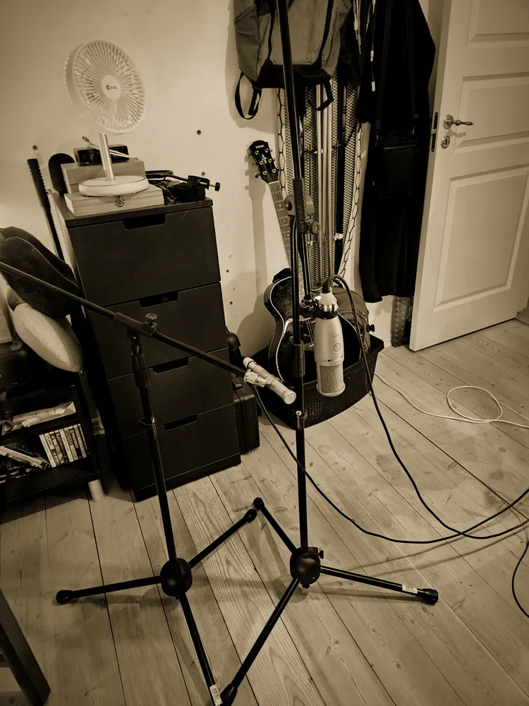 Mic stands, drawer units and instruments along the wall